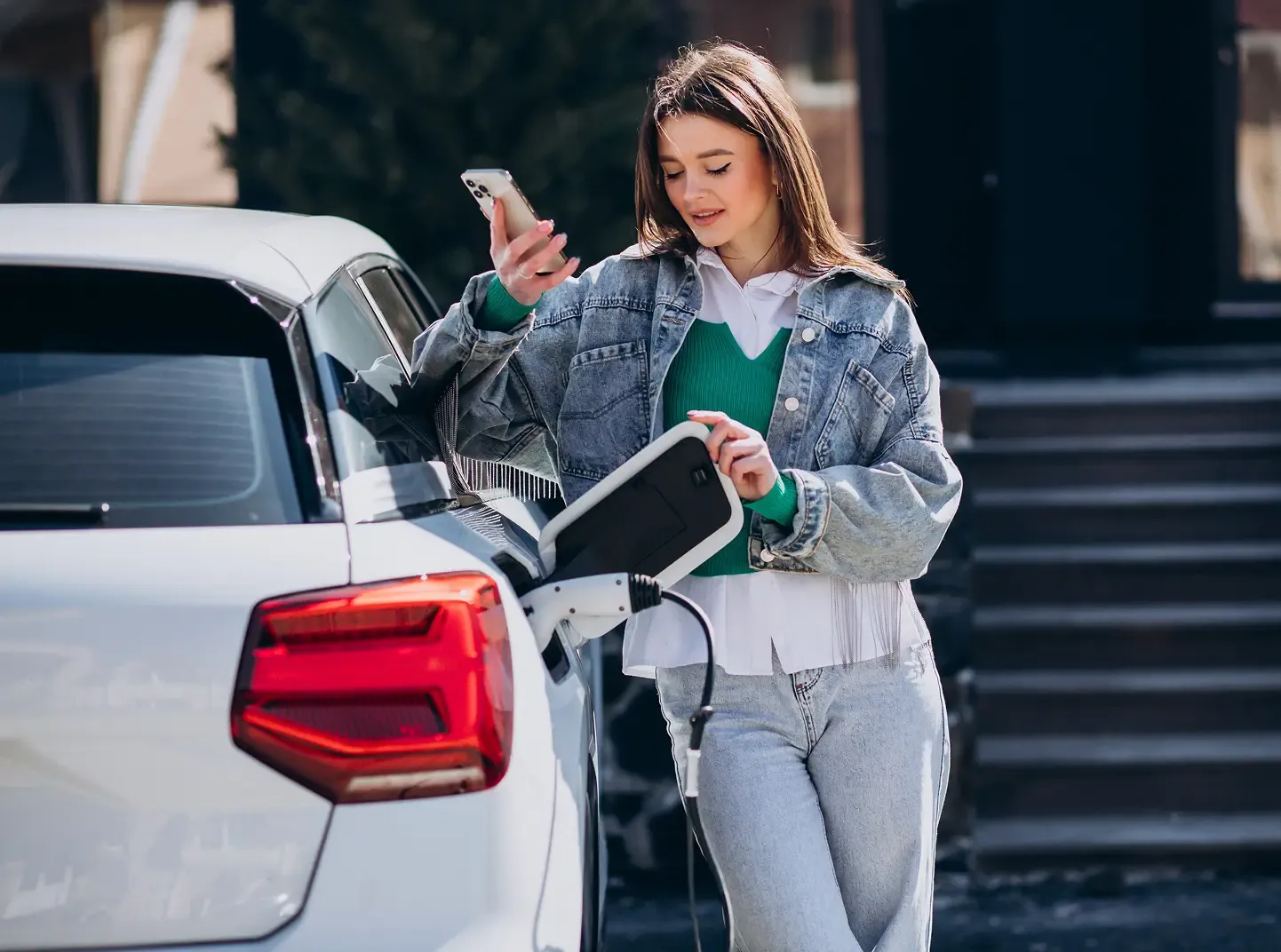 woman-charging-her-electric-car-with-charging-pistol