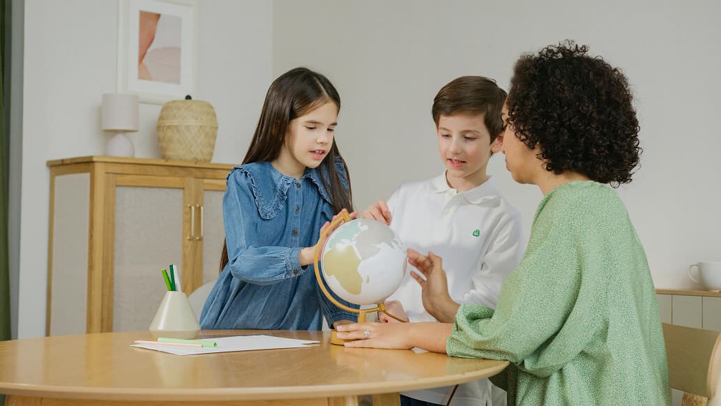 Kids looking at the globe